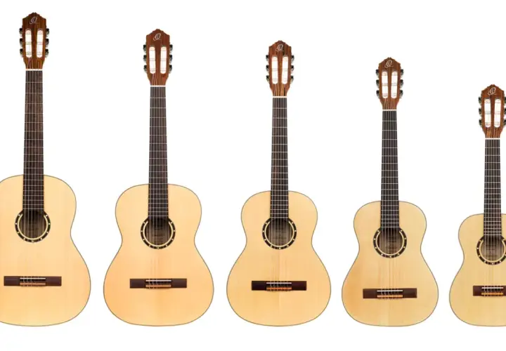Rząd gitar klasycznych o różnej wielkości. Najmniejsza gitara 3/4 idealna dla dziecka lub osoby o drobnej budowie.