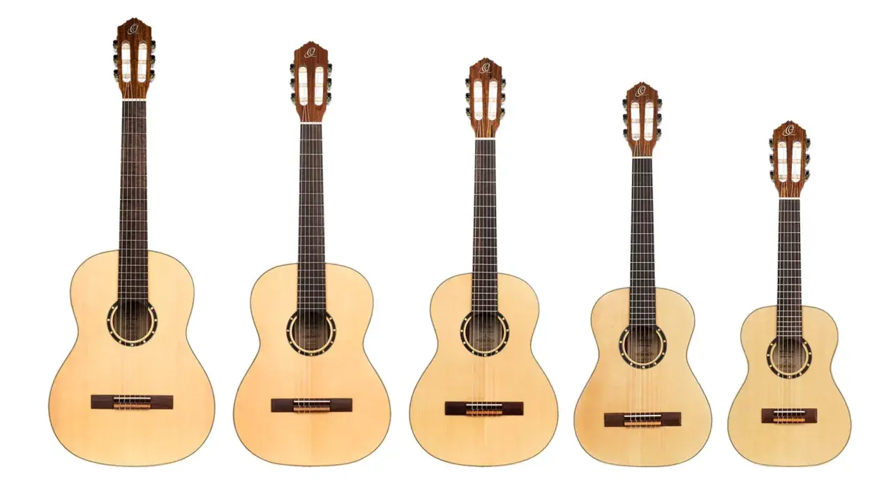 Rząd gitar klasycznych o różnej wielkości. Najmniejsza gitara 3/4 idealna dla dziecka lub osoby o drobnej budowie.